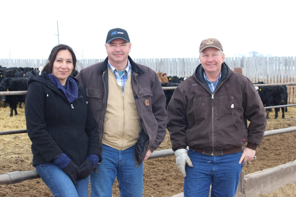 Dr. Claudia Narvaez(left) and mentor Tom Teichroeb (centre) tour Martin Unrau’s (right) feedlot